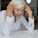 oral health and alzheimer's, forgetting, mouth-brain connection, women with her hand on her forehead