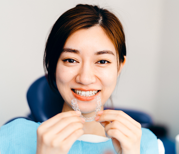 happy young woman with invisalign